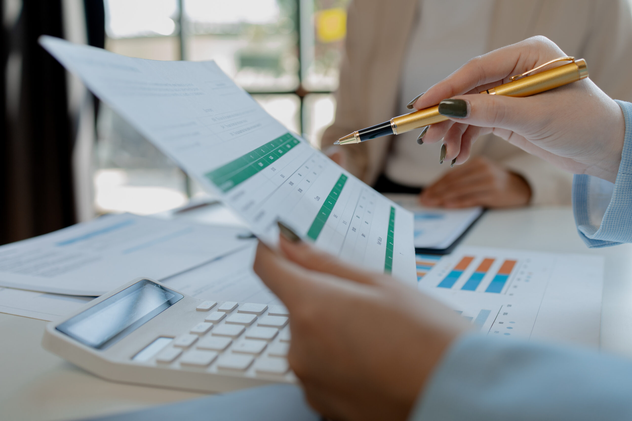 business colleagues working together on desktop computer at office, business professionals working on a tech project, Business colleagues talking to each other,
